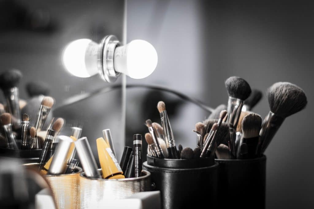 Natural white light is the perfect light for makeup application a Vanity mirror with a lot of makeup brushes in front of it