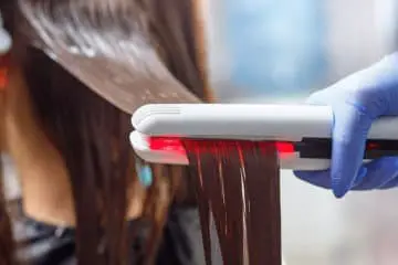 Girl getting her hair permanently straightened and wondering if will stop hair growth